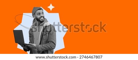 Young Man Using Laptop While Smiling in a Bright Orange Background