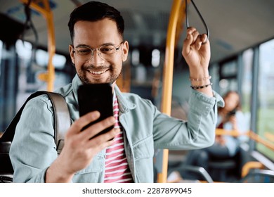 Young man using mobile phone while commuting by public transport. - Powered by Shutterstock