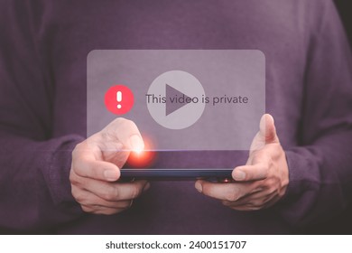 Young man using a mobile phone to play social media but this video is blocked or privacy settings have been set. Searching for more internet, and search engine optimization. Subscribing and following.