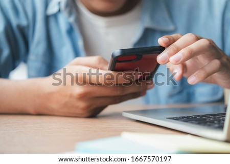 Young man using mobile phone. Using online connect technology for business, education and communication. 
