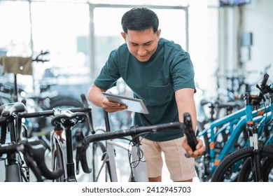 young man using a pad while trying out a bicycle grip handle at a bicycle shop - Powered by Shutterstock