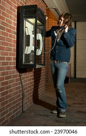 Young Man Using Payphone