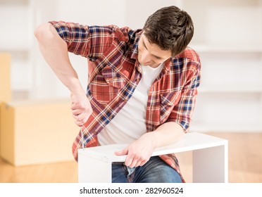 Young Man Using Repair Tools To Build New Furniture.