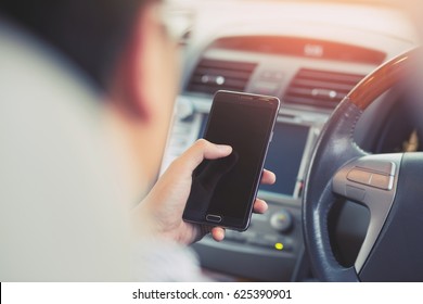 Young Man Using  Smart Phone Mobile Phone In Car.