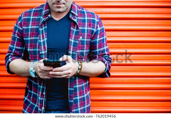 Young Man Using Smartphone Front Orange Stock Photo Edit Now
