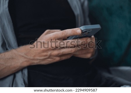 Young man using smartphone in hand, cafe, office,outdoor portrait business man, hipster style, internet, smartphone, office, Bali Indonesia, holding, mac OS, manager, freelancer, concept