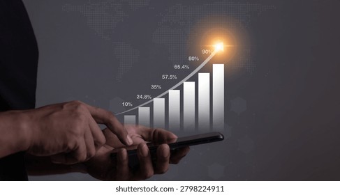 Young man using smartphone to visualize money growth The phone screen displays graphs and charts showing increasing investment and savings trends, along with an increased account balance