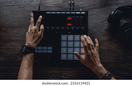 Young man using synth pads, make music - Powered by Shutterstock