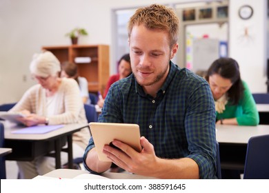 Young Man Using Tablet Computer At An Adult Education Class