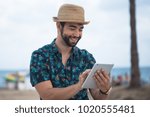 young man using a tablet during his travel