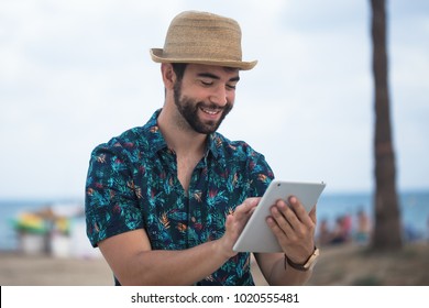 young man using a tablet during his travel
