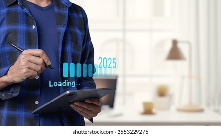  young man using a tablet in a modern office, visualizing future concepts for 2025. The scene shows a blend of technology, innovation, and workspace dynamics. Progress and transition  2024 to 2025 