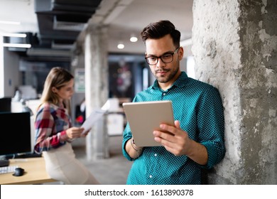 Young Man Using Technology, Digital Tablet In Corporate Business Office