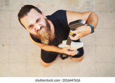 Young Man Using Video Game Toy Guitar To Simulate He Is Playing It