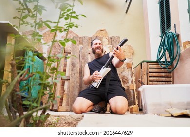 Young Man Using Video Game Toy Guitar To Simulate He Is Playing It