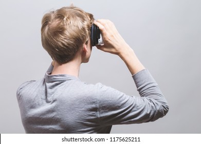 Young Man Using A Virtual Reality Headset From Behind