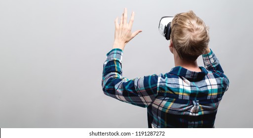 Young Man Using A Virtual Reality Headset From Behind