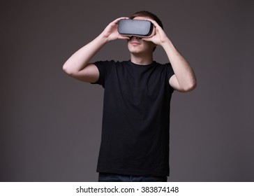 Young man using Virtual Reality glasses