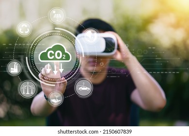 Young man using VR virtual reality headset with Reduce CO2 emission concept in the hand for environmental, global warming, Sustainable development and green business based on renewable energy. - Powered by Shutterstock