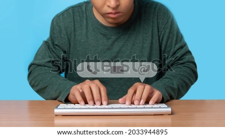 Young man using wireless keyboard with icon phone, mail, and address. Customer support service contact us concept.