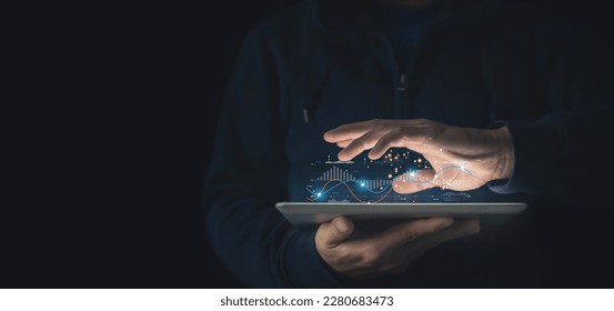 Young man utilizing tablet to analyze economic growth graphs, sales statistics, and block chain technology over a dark background global network. - Powered by Shutterstock - Get 15% off with code: PIKWIZARD15