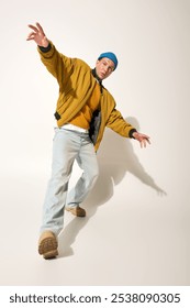 The young man in a vibrant outfit expresses creativity and confidence in his pose.