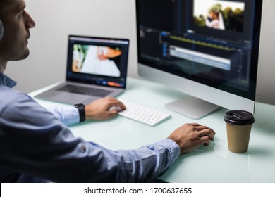 Young Man Video Editor With Works With Footage On His Personal Computer With Big Display In Office