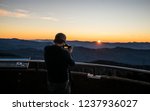 Young man viewing sunrise at the top of Clingman