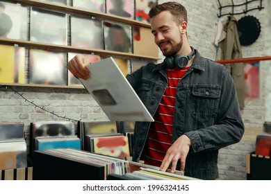 Young Man With Vinyl Record In Store