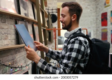 Young Man With Vinyl Record In Store