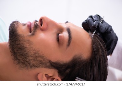 Young man visiting female beautician in hair transplantation con - Shutterstock ID 1747746017