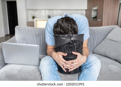 Young Man Vomiting In Rubbish Bin After Exhausting Busy Work Day	