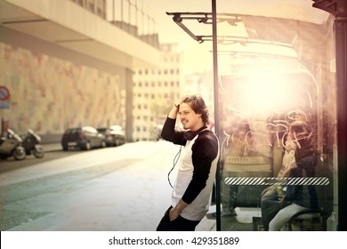 Young Man Waiting At The Bus Stop