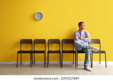 Young man waiting for his turn in room