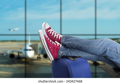 Young Man Waiting For The Plane At An Airport