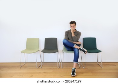 Young Man In Waiting Room For Job Interview