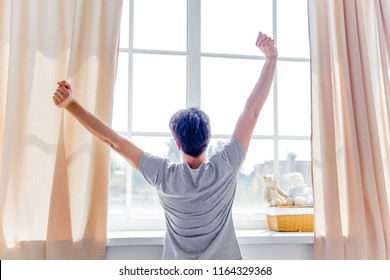 A Young Man Waking Up In Bed In The Morning