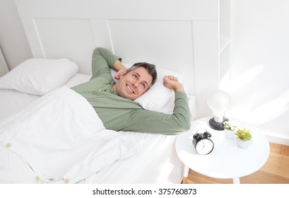 Young man waking up fully rested - Powered by Shutterstock