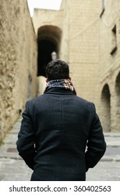 Young Man Walking Alone, Shot From Behind