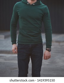 Young Man Walking In A Green Hoodie