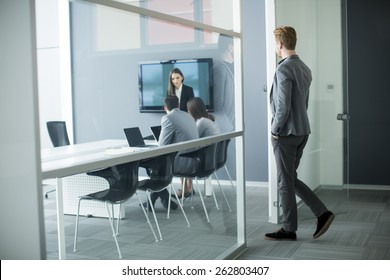 Young Man Walking Into Office