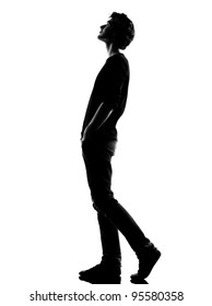 young man  walking looking up silhouette in studio isolated on white background