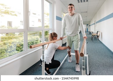 Young man in walking rehabilitation course after a sport injury on his knee