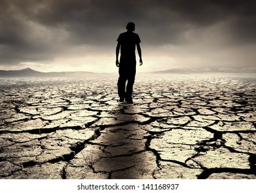 A young man walks into the desolate desert