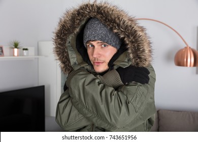 Young Man With Warm Clothing Feeling The Cold Inside House