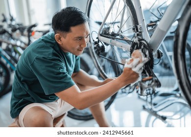 young man washes new bicycle gear with soap at a bicycle shop - Powered by Shutterstock