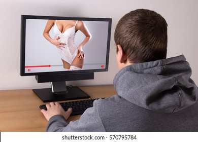 young man watching erotic video with sexy woman in lingerie