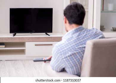 Young Man Watching Tv At Home