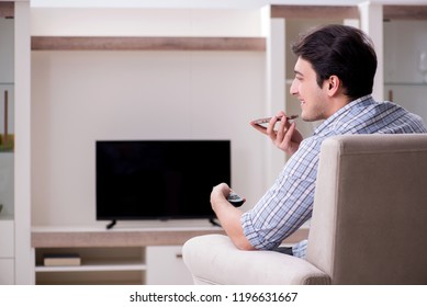 Young Man Watching Tv At Home