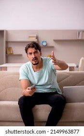 Young Man Watching Tv At Home